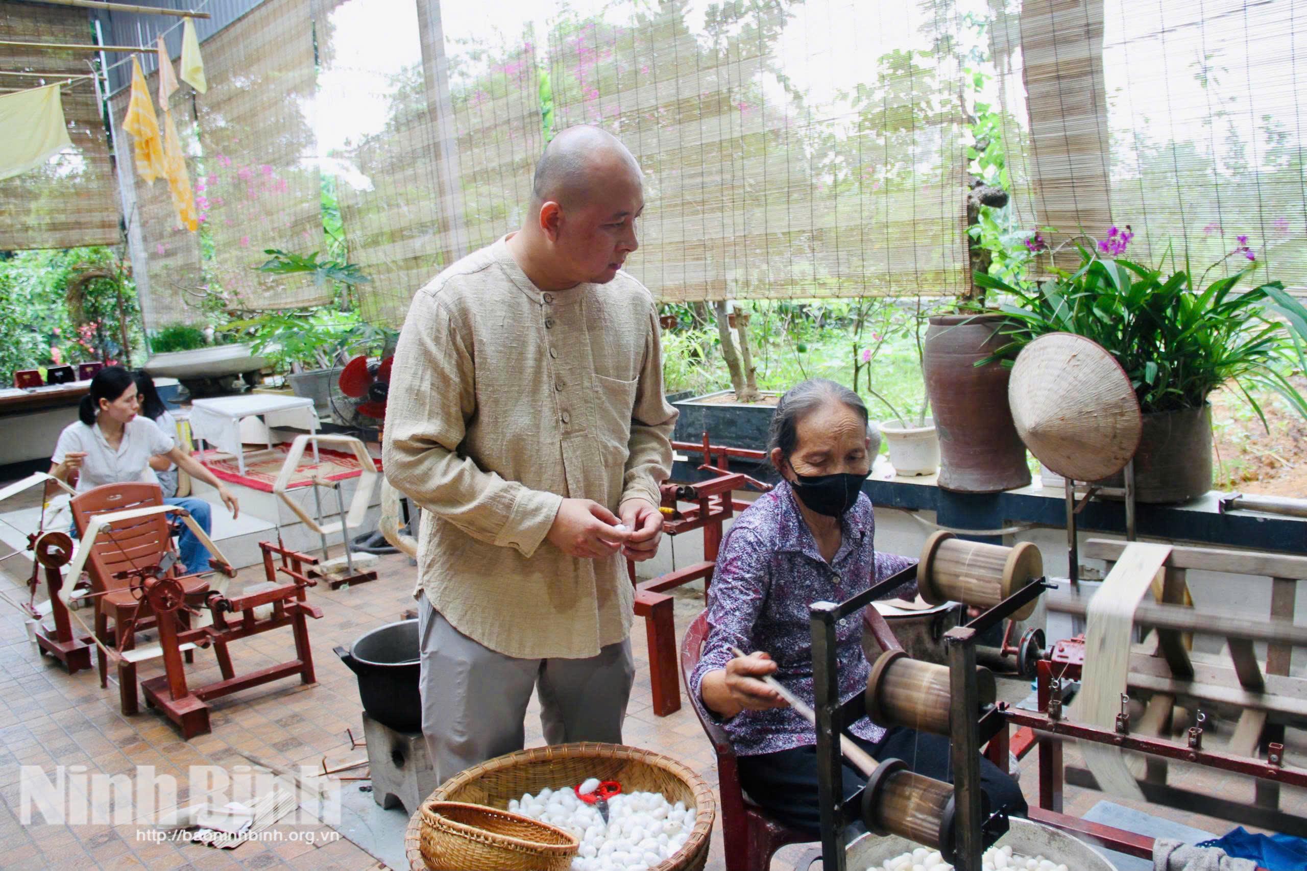 Anh Lê Văn Vụ, Giám đốc HTX Kỹ nghệ dệt lụa tơ tằm và thêu rua Hoa Lư kiểm tra sản phẩm tơ tằm.