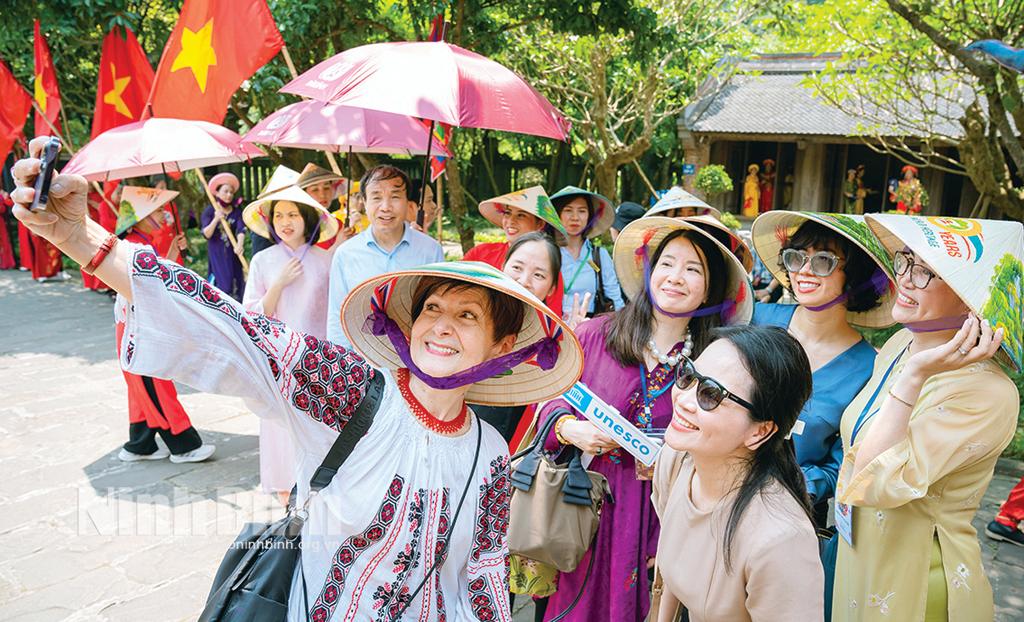 Bà Simona Mirela Miculescu, Chủ tịch Đại hội đồng UNESCO lần thứ 42 chụp ảnh cùng du khách khi về thăm Tràng An. Ảnh: CTV