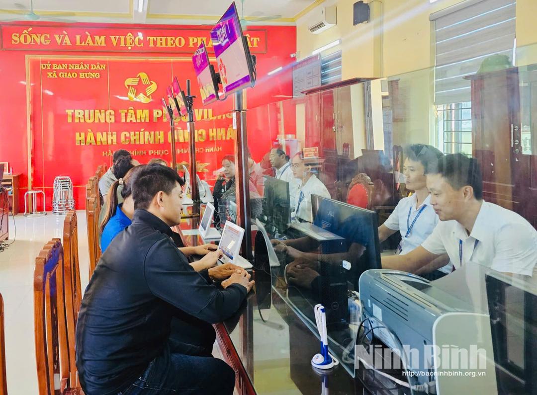 Cán bộ Trung tâm Phục vụ hành chính công xã Giao Hưng hướng dẫn người dân làm thủ tục hành chính. Ảnh: Minh Hải