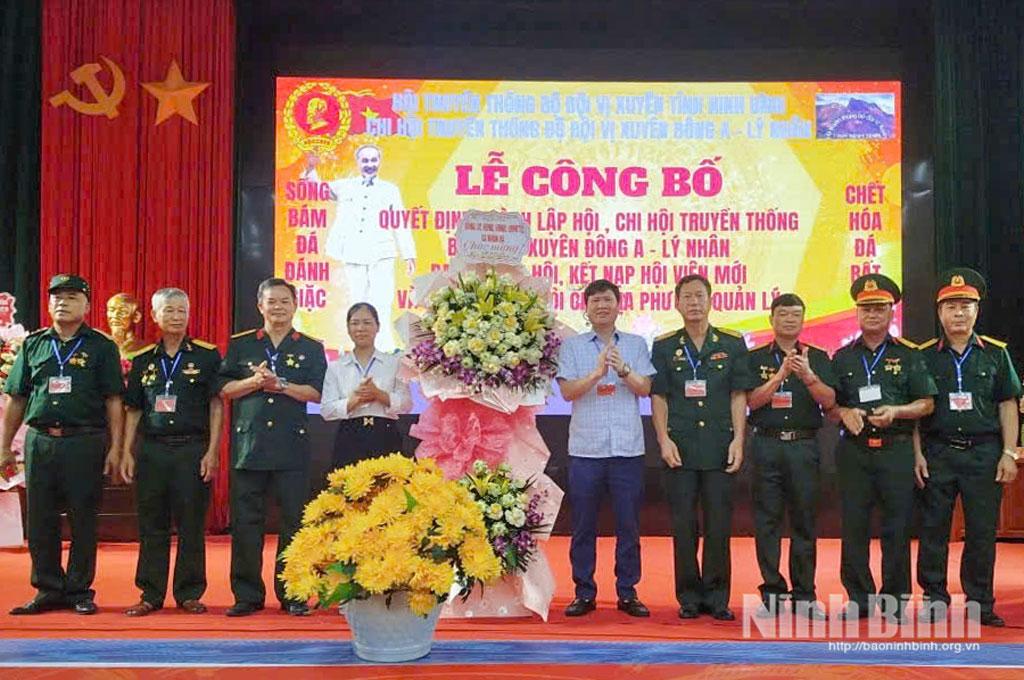 Lãnh đạo xã Nhân Hà và Hội truyền thống bộ đội Vị Xuyên tỉnh tặng hoa chúc mừng.