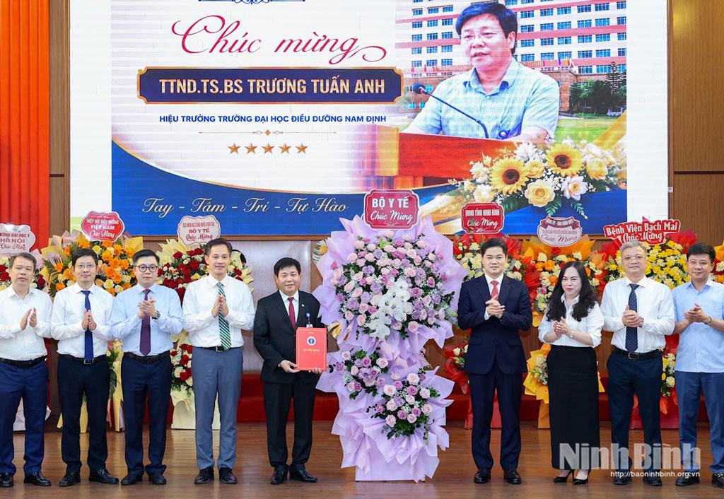Đồng chí Vũ Mạnh Hà, Ủy viên dự khuyết Trung ương Đảng, Thứ trưởng Thường trực Bộ Y tế và đại diện Bộ Y tế tặng hoa chúc mừng Hiệu trưởng.